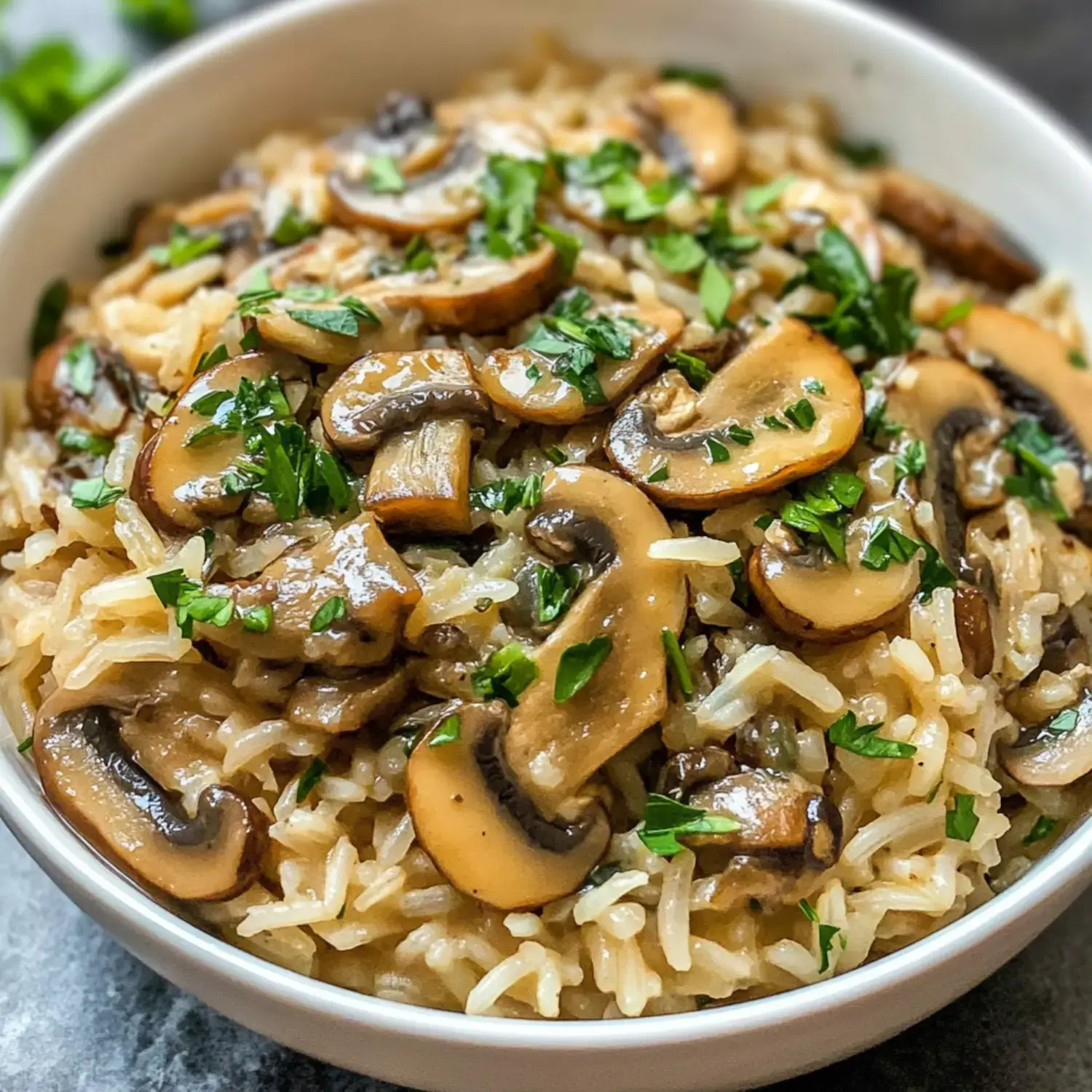 Cooked rice topped with sautéed mushrooms and parsley.