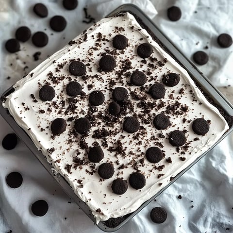 Smooth no-bake cookies and cream mousse cake with delicious chocolate and Oreo layers.