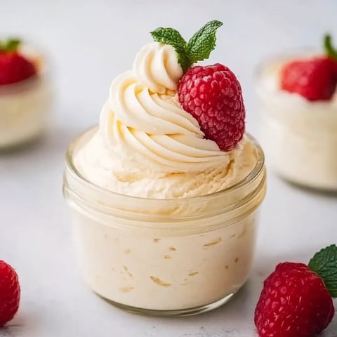 A creamy classic vanilla mousse garnished with whipped cream.