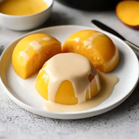 Dreamy mango pudding topped with fresh mango chunks, served chilled.